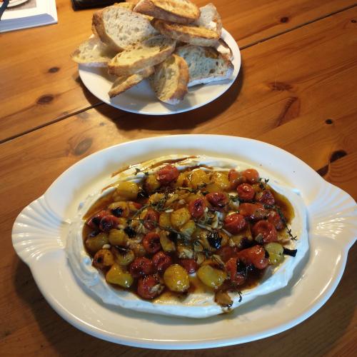 Cherry tomatoes over yogurt