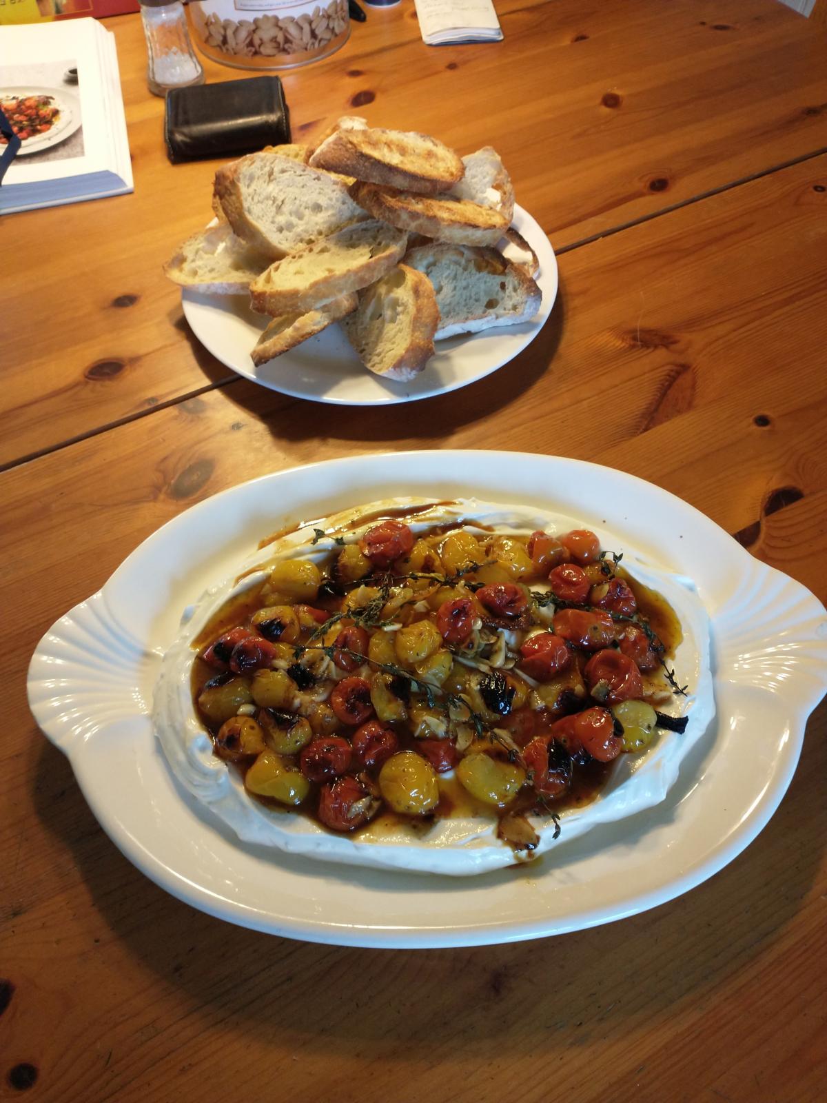 Cherry tomatoes over yogurt